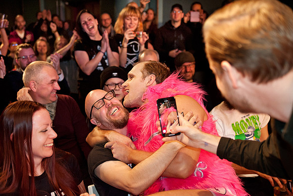 The spray-tanned, pink-clad douchebag Valentine taking liberties with the audience at Moriskan